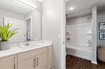 a bathroom with a large mirror and a sink and a shower