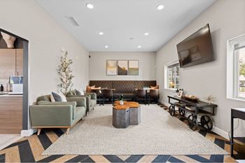 a living room with couches and chairs and a tv