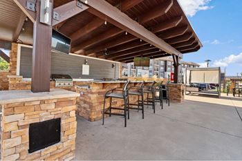 the preserve at ballantyne commons outdoor bar with fireplace and stools