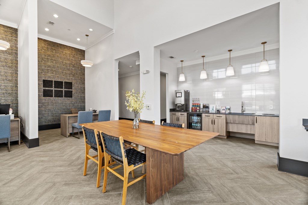 A dining room with a wooden table and chairs.