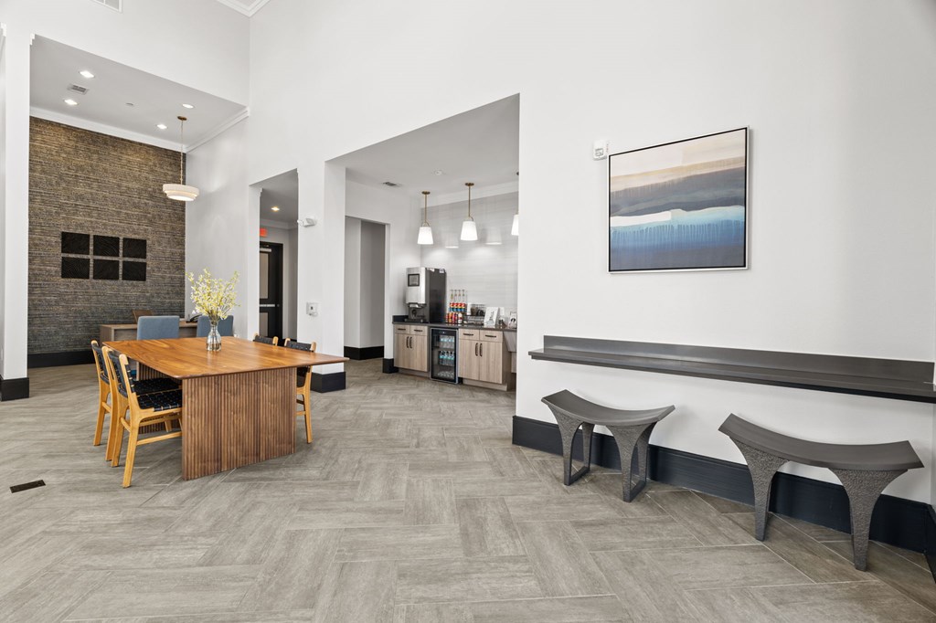 A modern dining room with a wooden table and chairs.