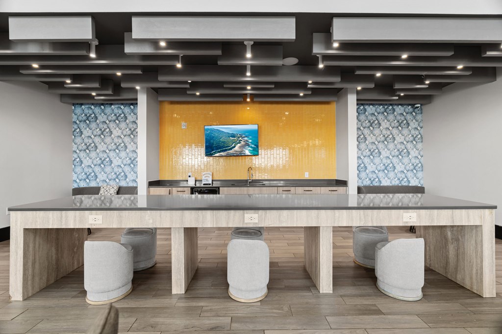 A modern kitchen with a long island and bar stools.