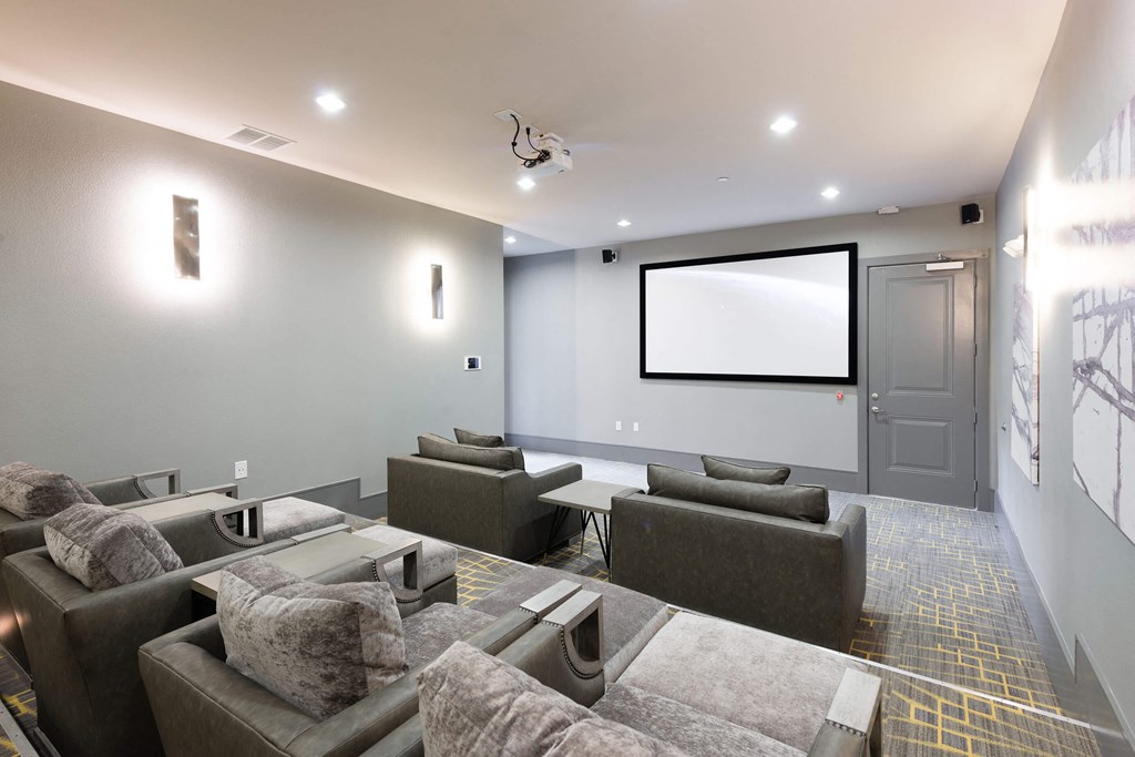 A modern home theater with a large screen and comfortable seating.