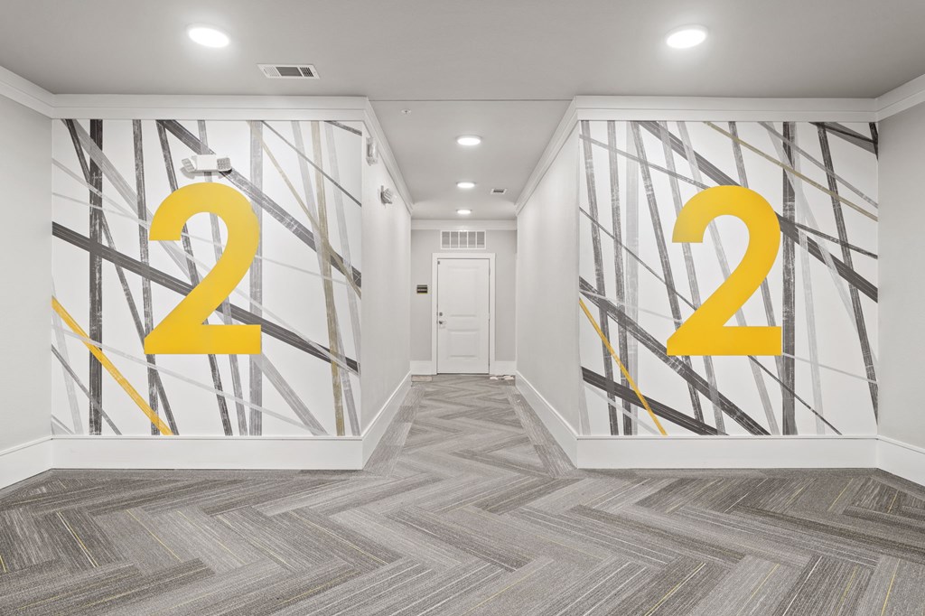 A hallway with a large number 2 painted on the wall.