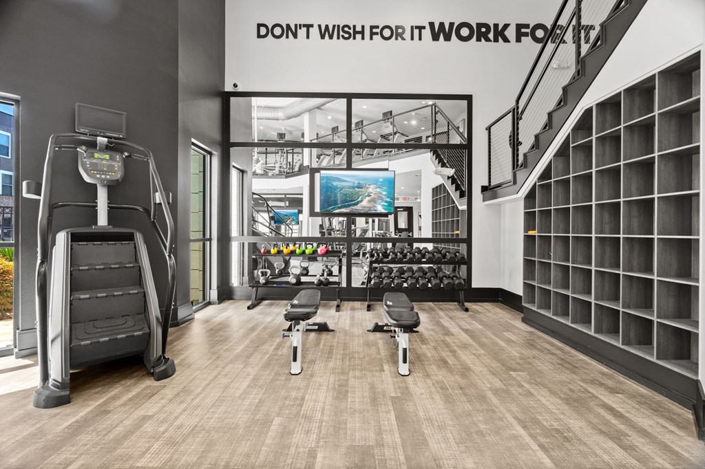A gym with a sign that says "Don't wish for it, work for it".