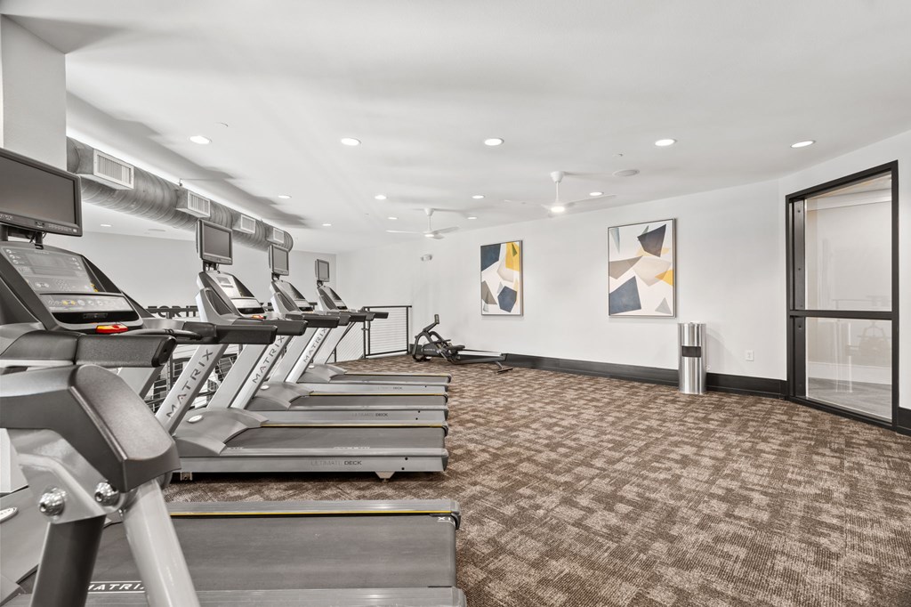 A gym with treadmills and exercise equipment.