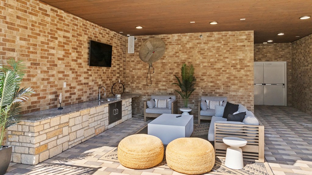 A patio with a fireplace and seating area.