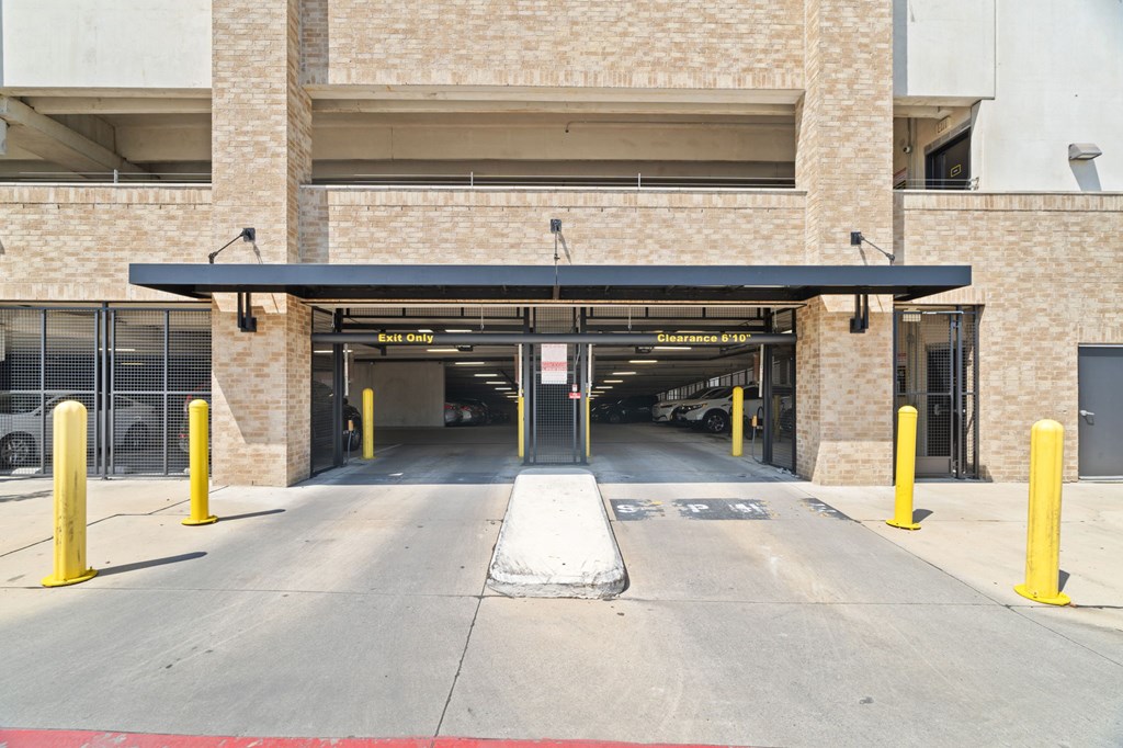 A parking garage entrance with a sign that says "Entrance 1".