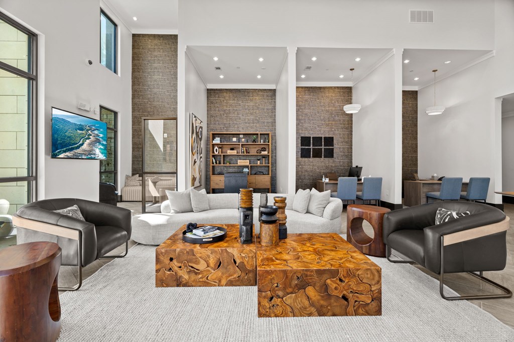 A modern living room with a wooden coffee table in the center.