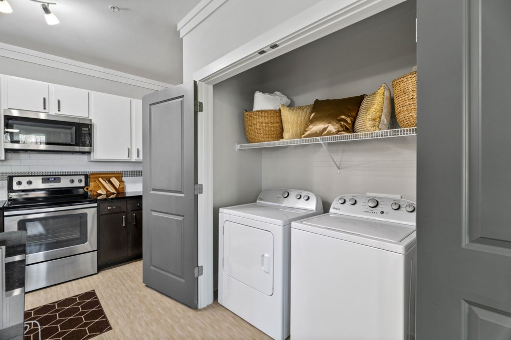 A modern kitchen with a white oven and microwave.