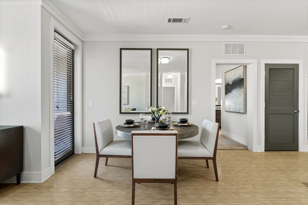 A dining room with a table set for two.