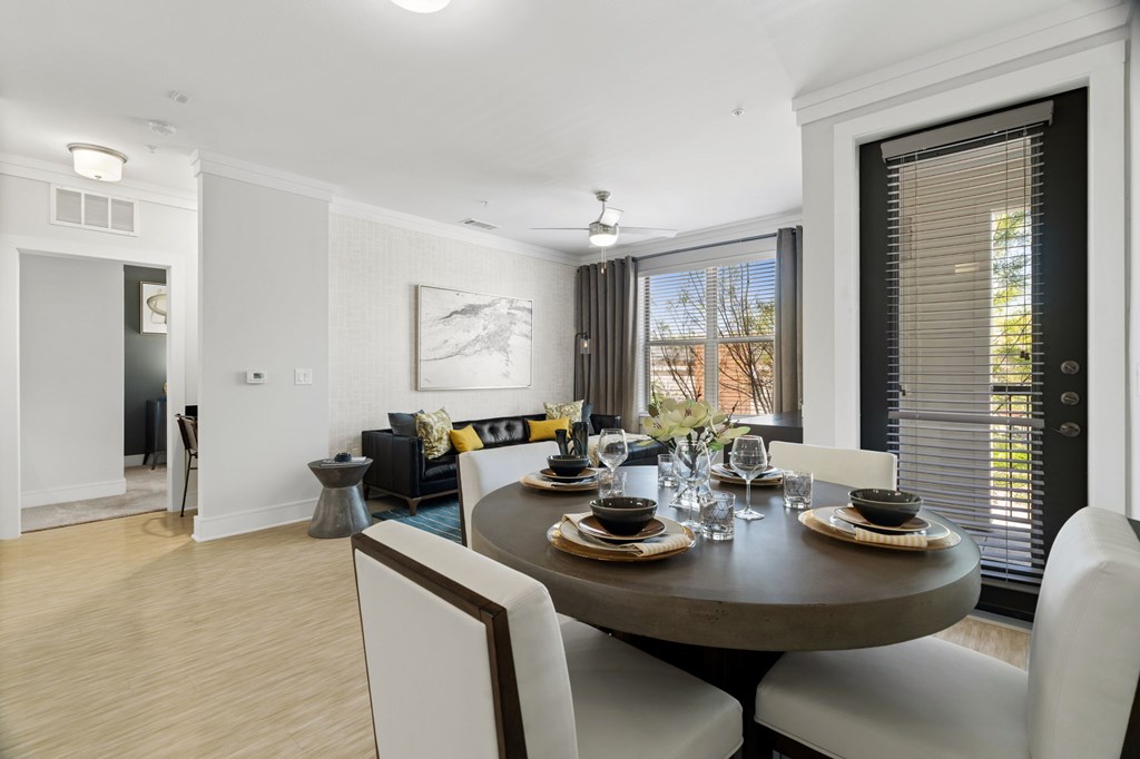 A dining room with a round table set for six.