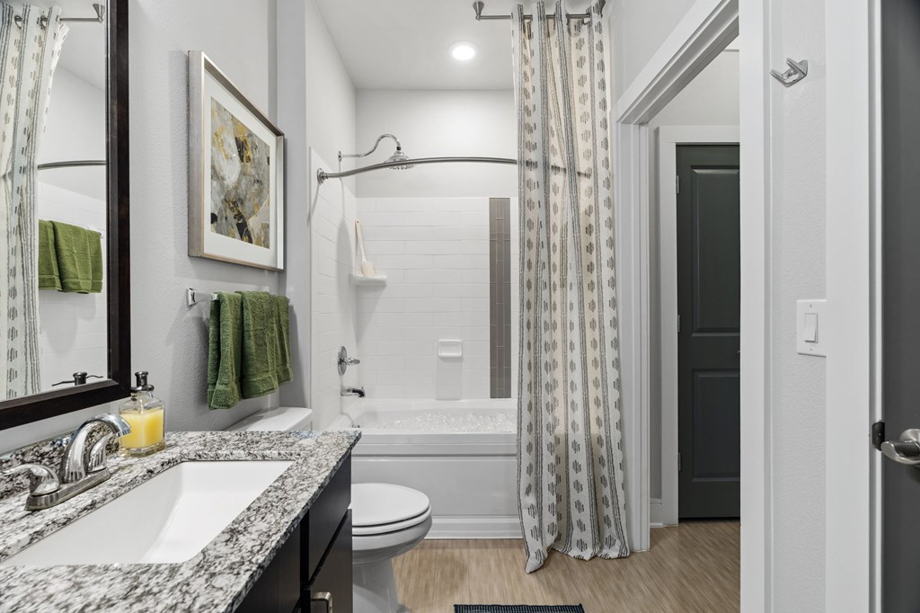 A bathroom with a white toilet and a white sink.