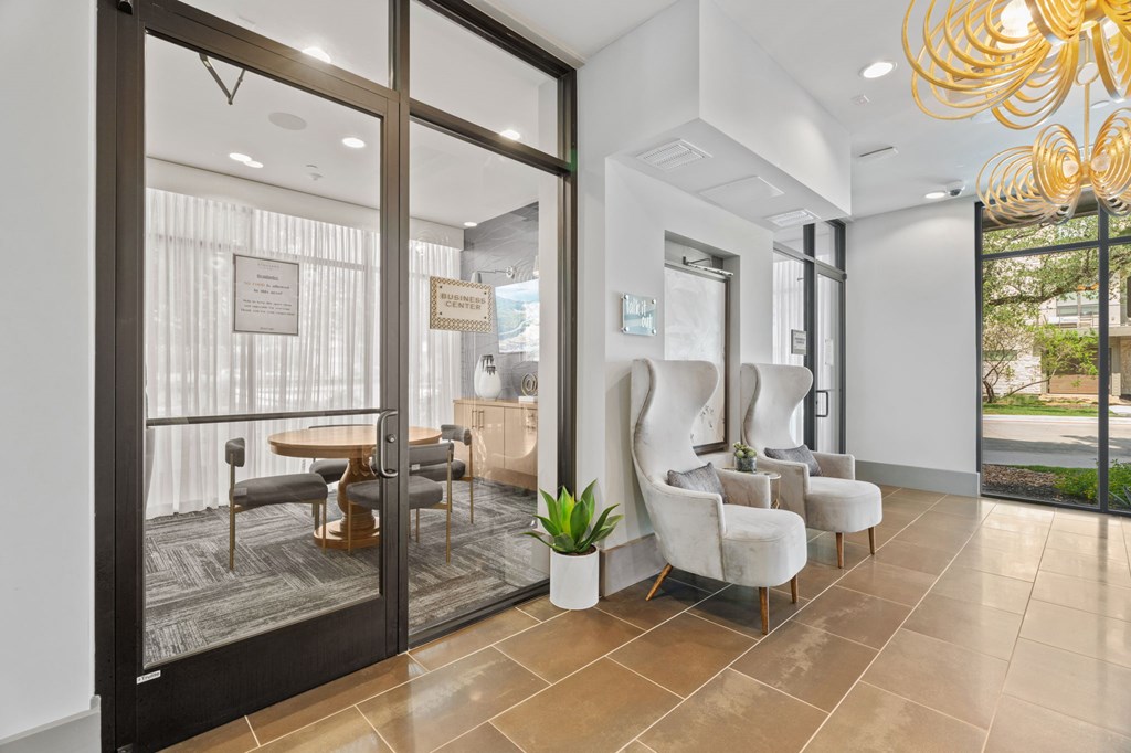 A modern living room with a glass door leading to a balcony.