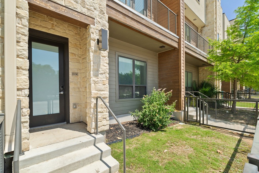 A building with a stone pillar and glass door.