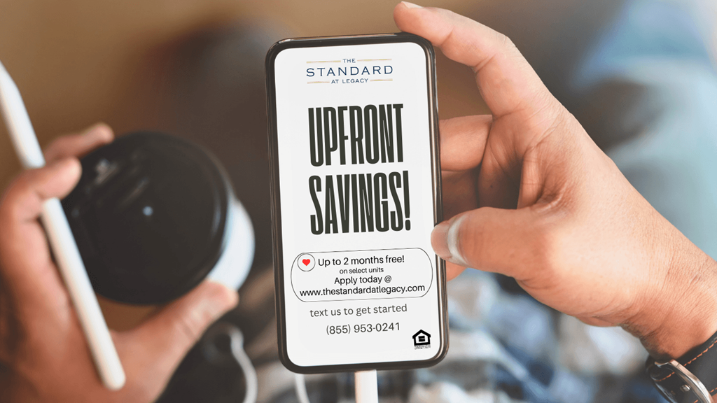 A person holding a smartphone displaying an offer for up to 2 months free.