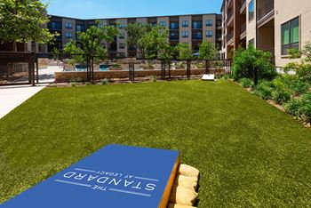 A blue book with the word "CONSERVATORY" on it is placed on a lawn.