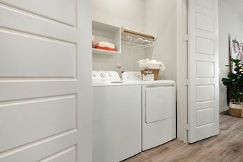 A white laundry room with a washer and dryer.