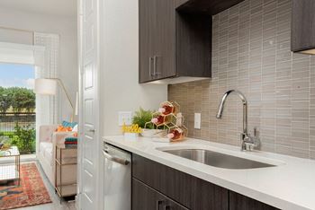 A kitchen with a white countertop and a modern design.
