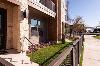 A building with a stone pillar and a black gate.