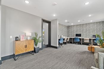 A conference room with a long table and chairs.