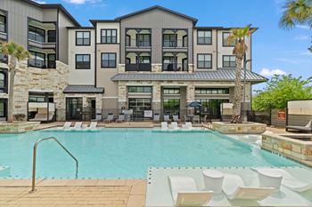 A large building with a pool in front.