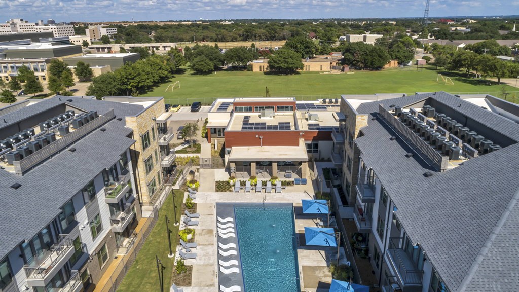 A large building with a pool in the middle of it.