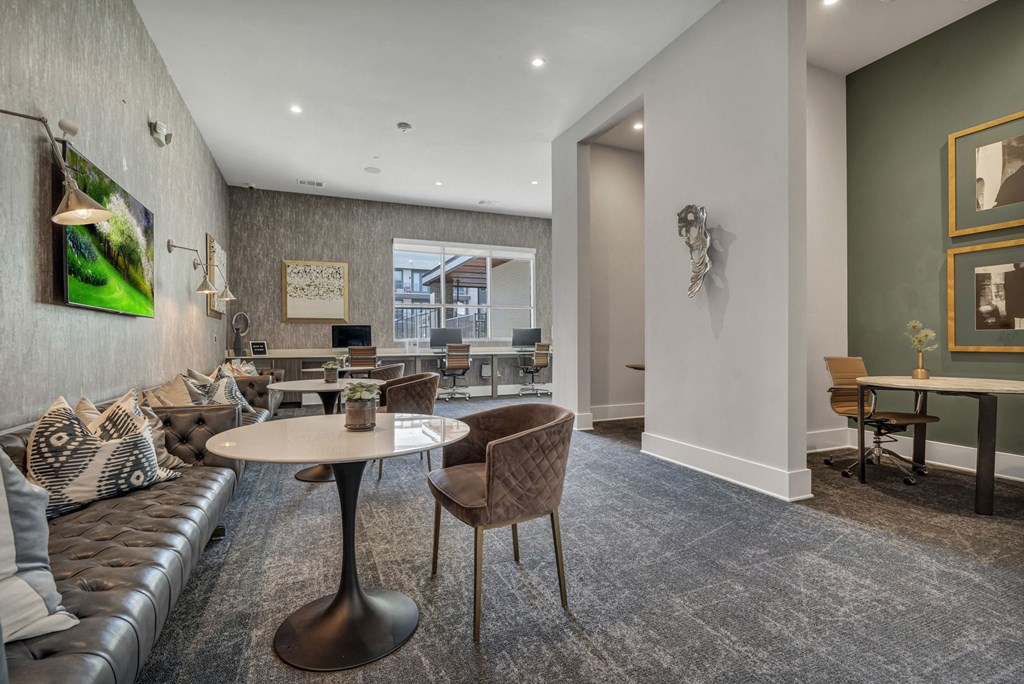 A modern living room with a grey carpet and a white table.
