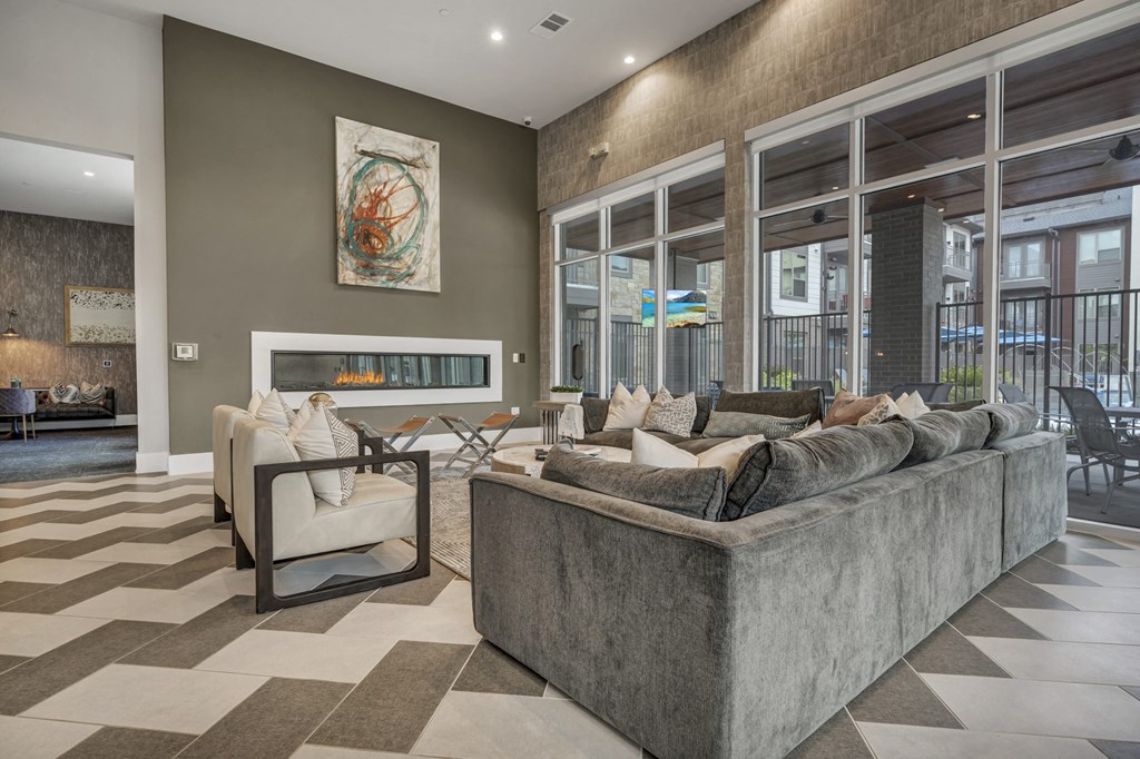A living room with a grey sofa and a checkered floor.