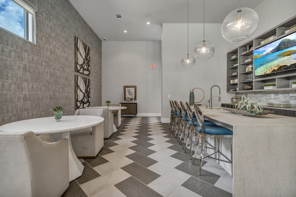 A modern dining room with a long table and chairs.