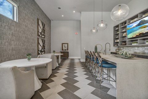 A modern dining room with a long table and chairs.