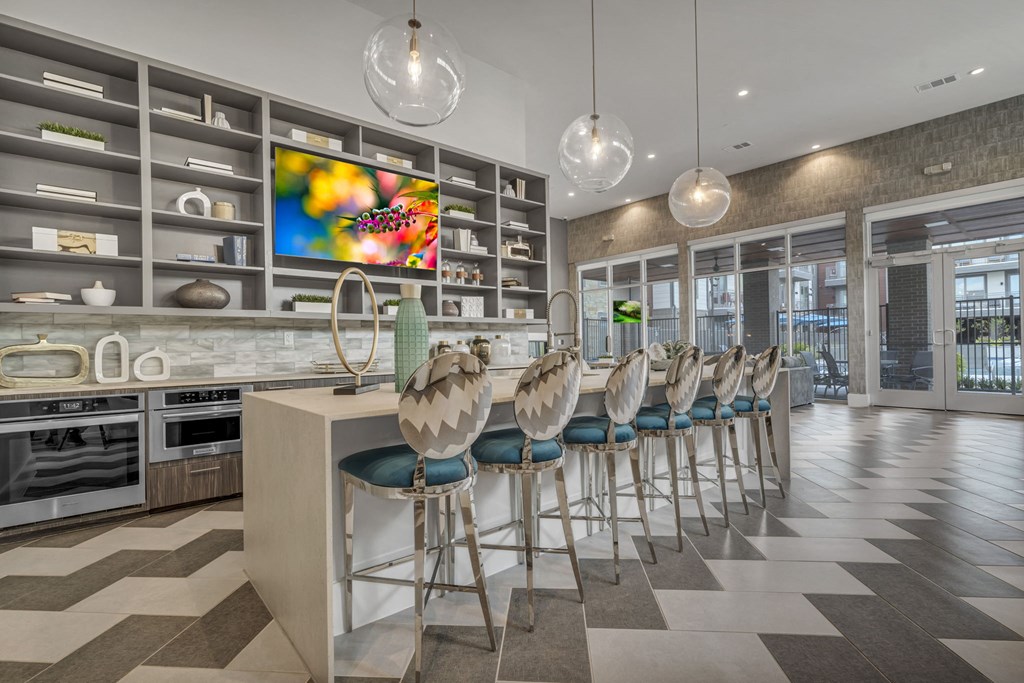 A modern kitchen with a bar area and a large painting on the wall.