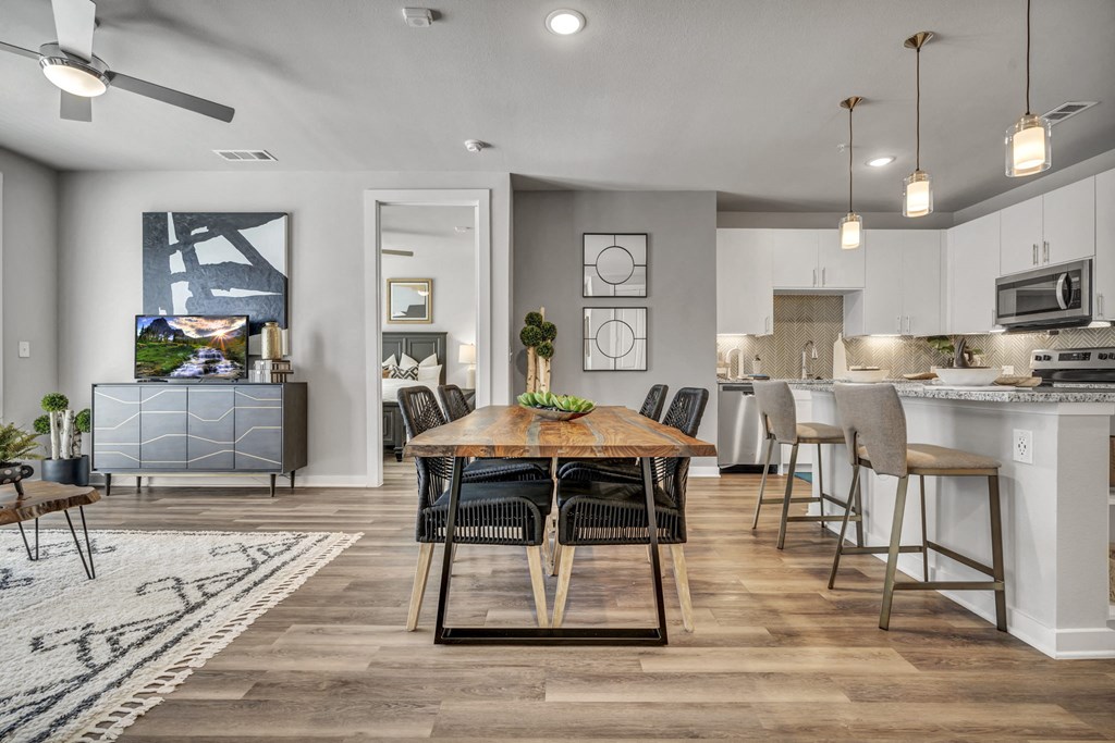 A modern dining room with a wooden table and chairs.