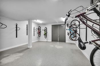 A bike is parked in a bike rack in a hallway.