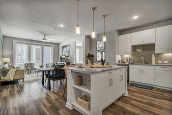 A modern kitchen with a dining table and chairs.