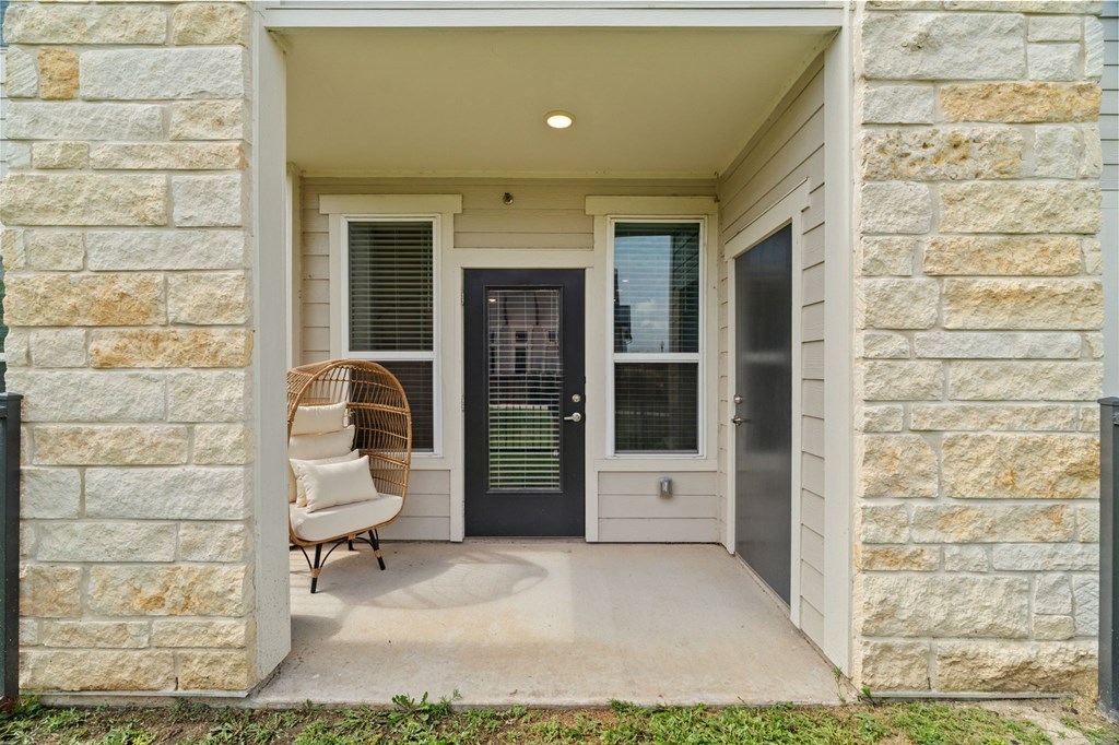 A house entrance with a chair and a door.