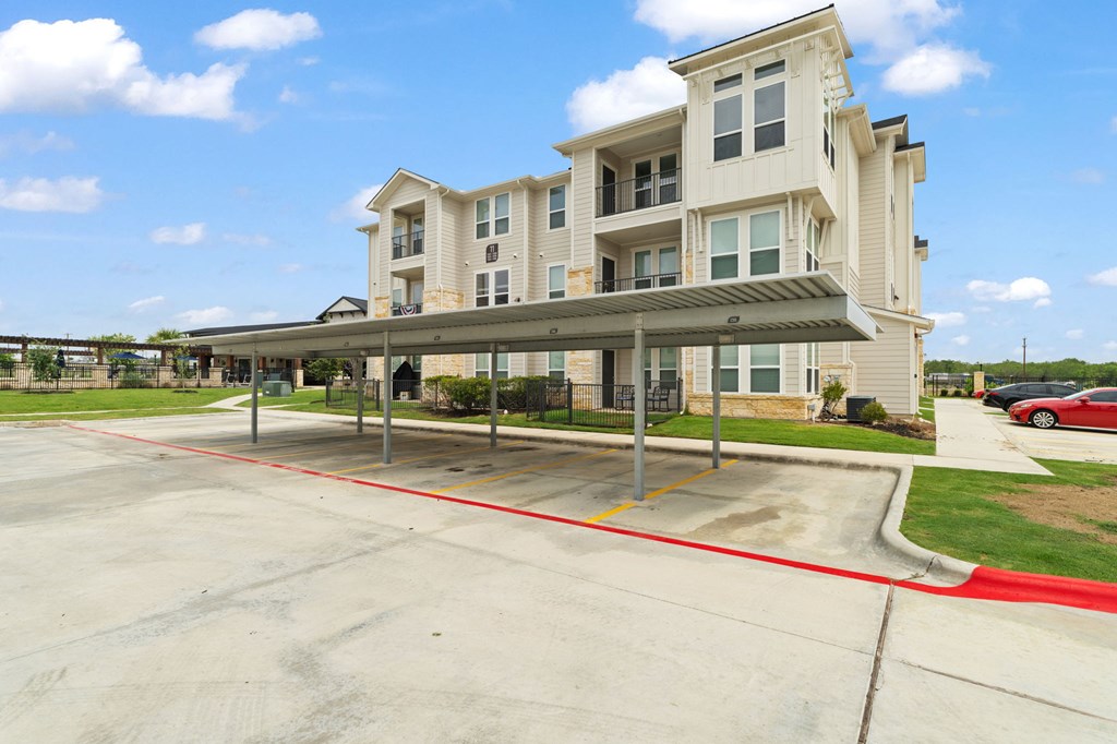 A large building with a parking lot in front.