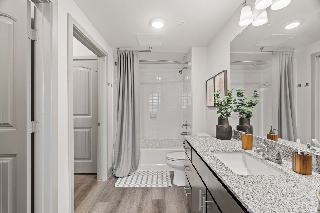 A bathroom with a white sink and a white toilet.