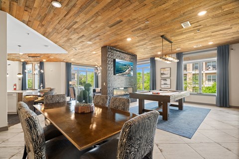 A modern dining room with a wooden table and chairs.