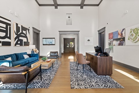 A modern living room with a dark blue sofa and a wooden coffee table.