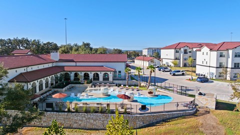A large building with a pool in front of it.