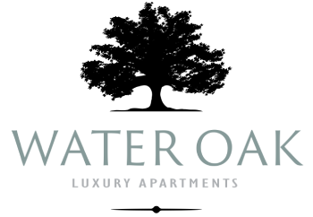 A black and white image of a sign that says Water Oak Luxury Apartments.