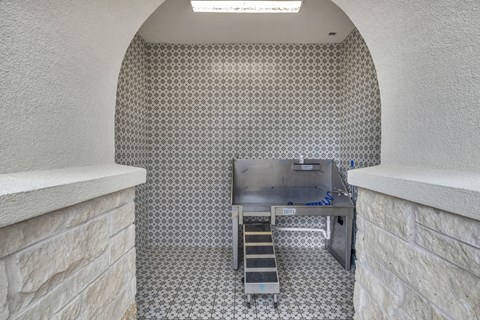 A kitchen with a stainless steel counter and a tiled floor.