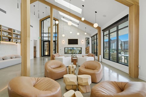 A modern living room with leather chairs and a television.