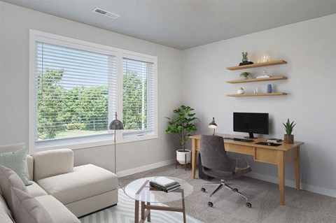 A modern home office with a desk, chair, and plants.