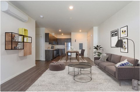 A modern living room with a grey sofa and a coffee table.