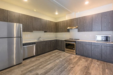 A modern kitchen with wooden cabinets and stainless steel appliances.