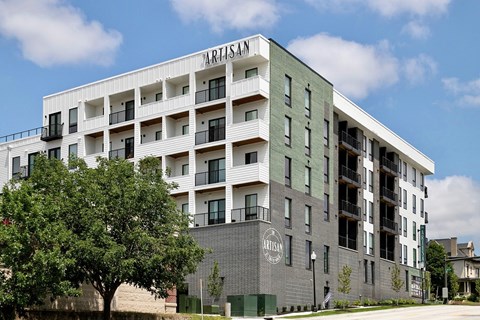 A large white building with the word "ARTISAN" on the side.