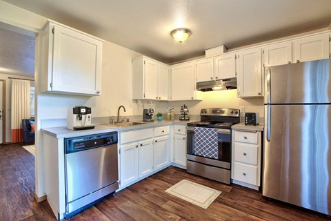 a kitchen with stainless steel appliances and white cabinets