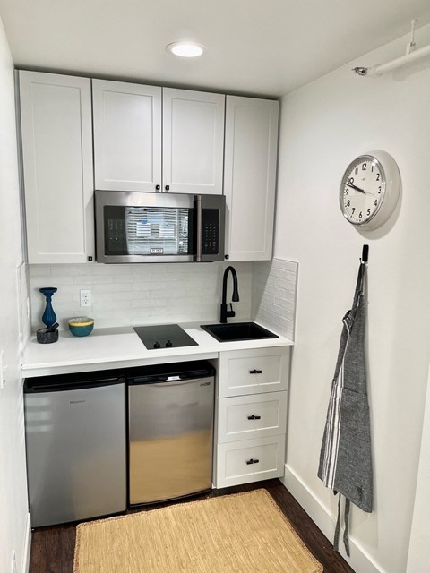 a small kitchen with a sink and a microwave